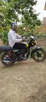 Education Secretary Alex Puhindei using his new motorbike